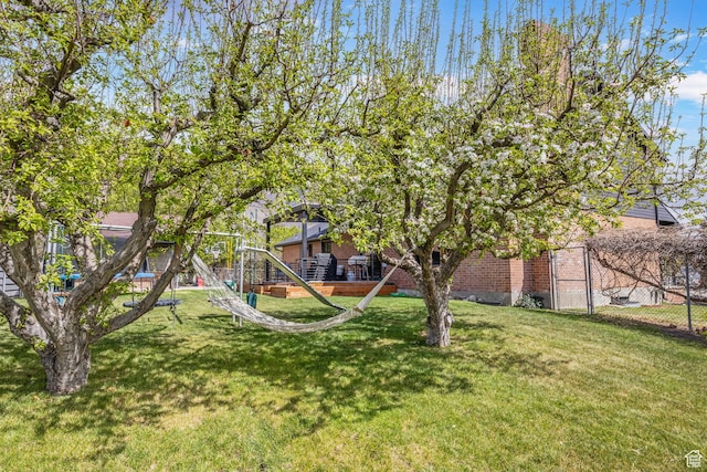 view of yard with fence and a playground