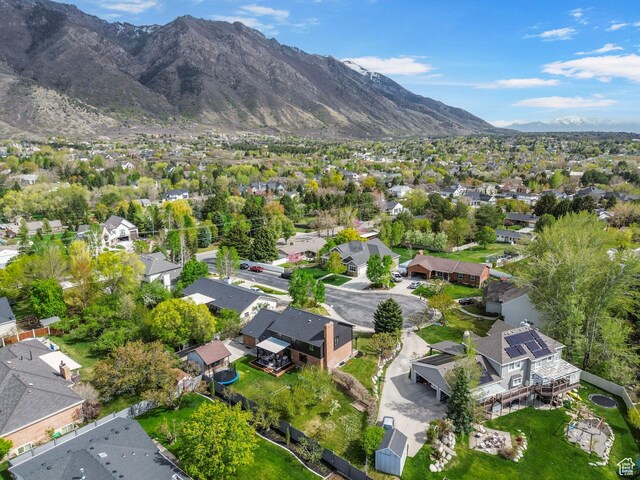 drone / aerial view featuring a residential view and a mountain view