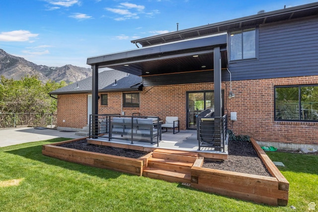 rear view of house with a patio, brick siding, and a vegetable garden