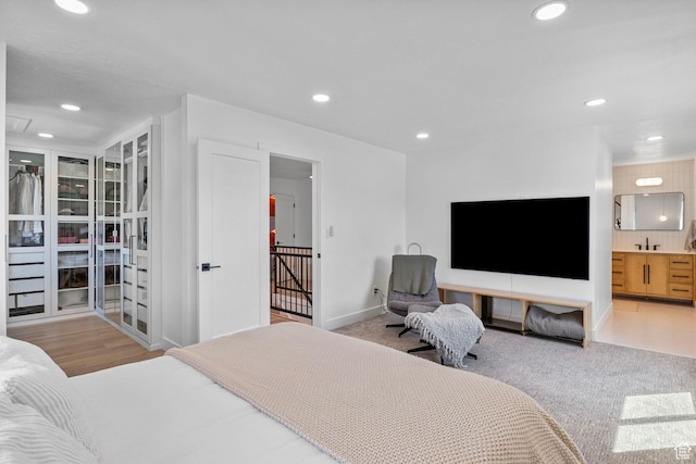 bedroom featuring recessed lighting, baseboards, and ensuite bath