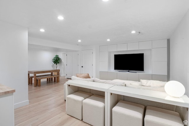 living room with baseboards, recessed lighting, and light wood-style flooring