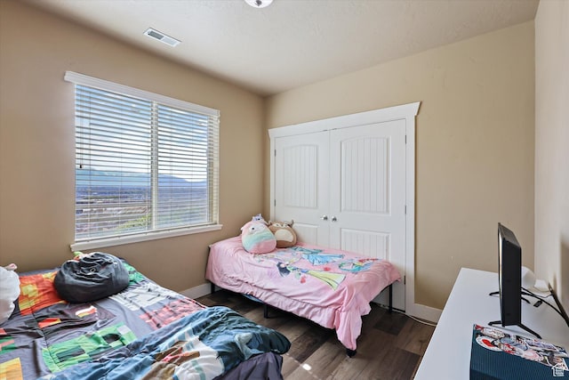 2153 N Springtime Dr, Saratoga Springs, UT 84045 - bedroom with dark wood finished floors, visible vents, a closet, and baseboards