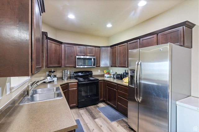 2153 N Springtime Dr, Saratoga Springs, UT 84045 - kitchen with a sink, stainless steel appliances, dark brown cabinets, light wood-type flooring, and recessed lighting