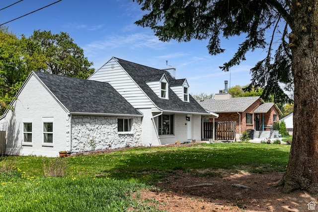 263 N 100 E, Springville, UT 84663 - view of front of house featuring a front yard, a shingled roof, and brick siding