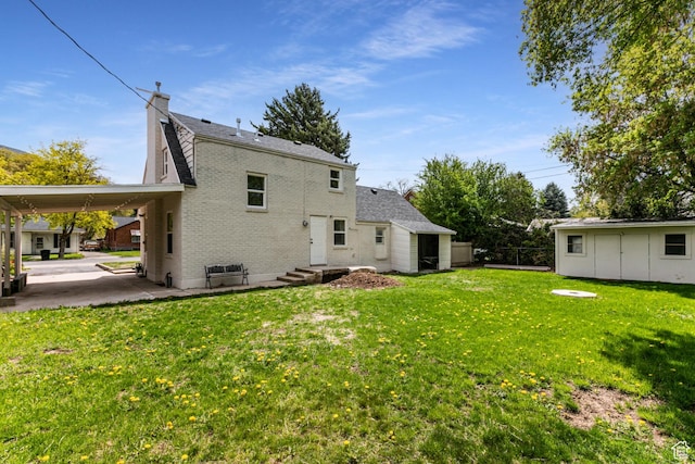 263 N 100 E, Springville, UT 84663 - rear view of house with brick siding, a yard, a chimney, entry steps, and fence