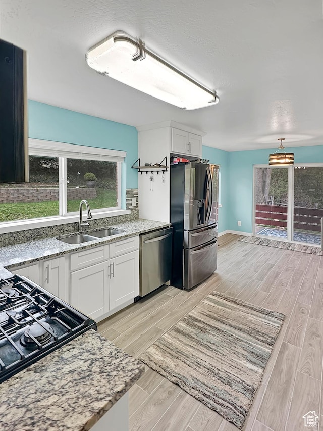 886 E Hillcrest Dr, Springville, UT 84663 - kitchen with white cabinets, stainless steel appliances, wood finish floors, and a sink