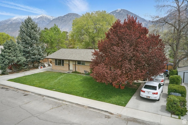 985 S 600 W, Provo, UT 84601 - view of front of property with a mountain view, a front lawn, concrete driveway, and brick siding