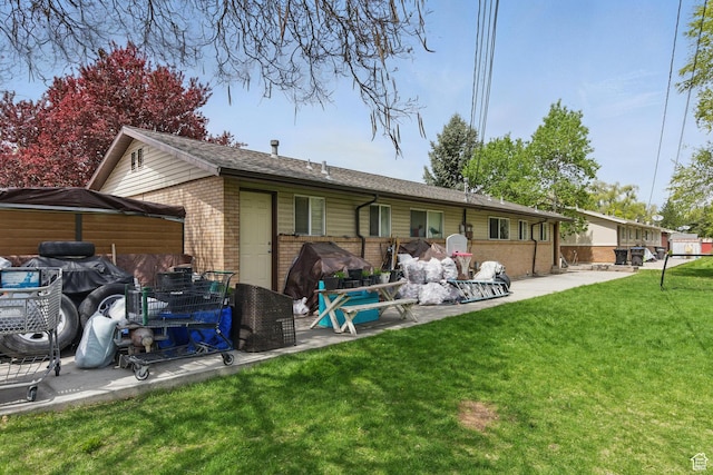 985 S 600 W, Provo, UT 84601 - rear view of property with brick siding, roof with shingles, a yard, and a patio area
