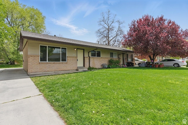 single story home featuring a front lawn and brick siding
