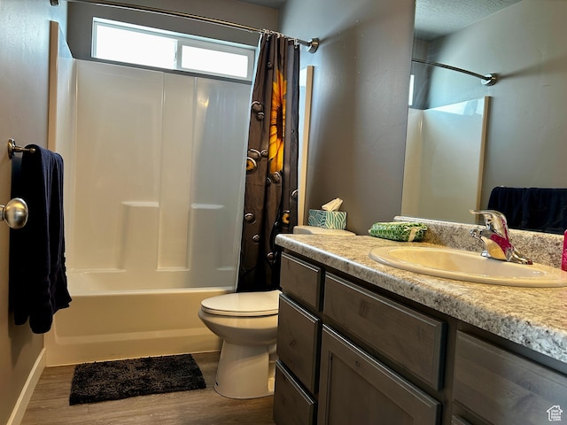 2045 E Mine Rock Rd, Lake Point, UT 84074 - full bathroom featuring wood finished floors, shower / bathtub combination with curtain, toilet, vanity, and baseboards