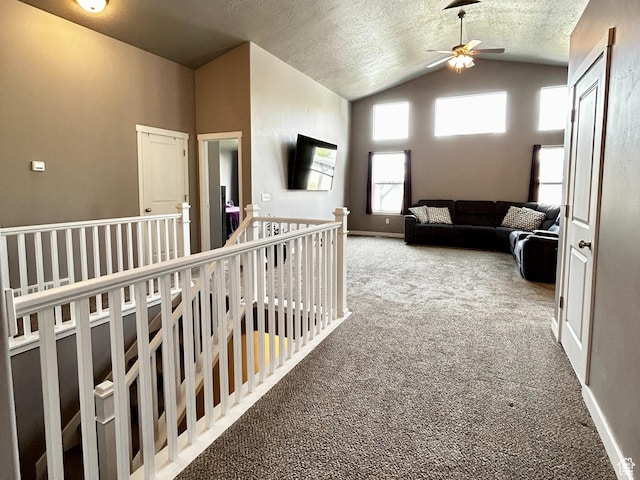 2045 E Mine Rock Rd, Lake Point, UT 84074 - corridor featuring a textured ceiling, an upstairs landing, baseboards, vaulted ceiling, and carpet