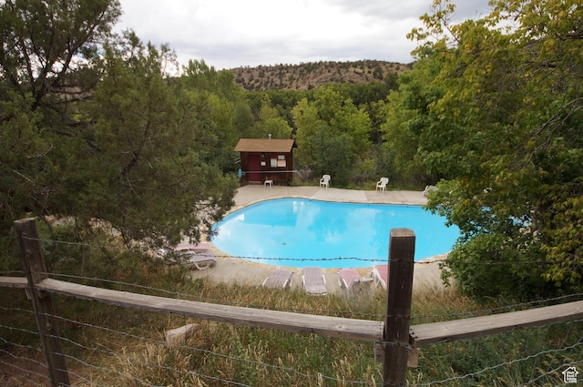 315 Abbey Rd, Moab, UT 84532 - view of pool featuring a forest view and a patio area