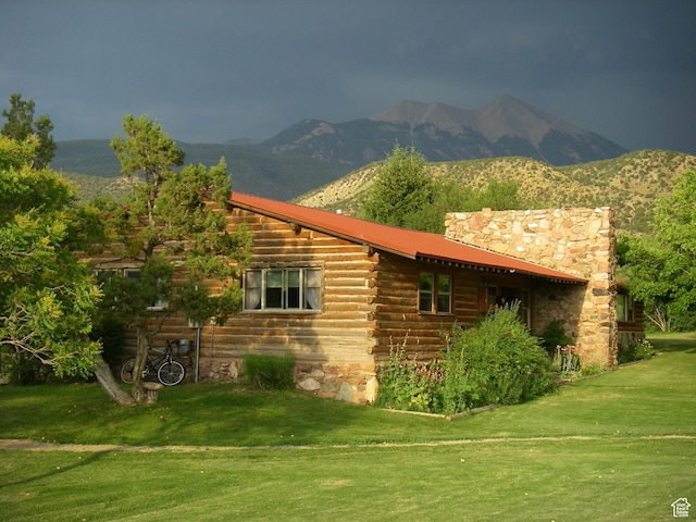 315 Abbey Rd, Moab, UT 84532 - view of side of property with log siding, a lawn, and a mountain view