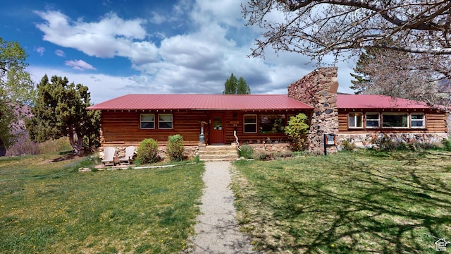 315 Abbey Rd, Moab, UT 84532 - log cabin with a chimney, metal roof, a front yard, and a porch