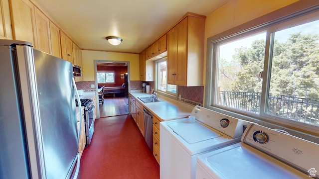 315 Abbey Rd, Moab, UT 84532 - kitchen with stainless steel appliances, independent washer and dryer, a sink, light countertops, and decorative backsplash