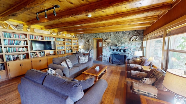 315 Abbey Rd, Moab, UT 84532 - living room featuring wood ceiling, hardwood / wood-style floors, beamed ceiling, and a stone fireplace