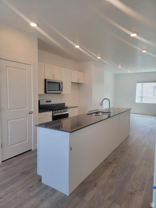 1146 W 310 S, American Fork, UT 84003 - kitchen featuring white cabinets, a sink, appliances with stainless steel finishes, dark countertops, and dark wood finished floors