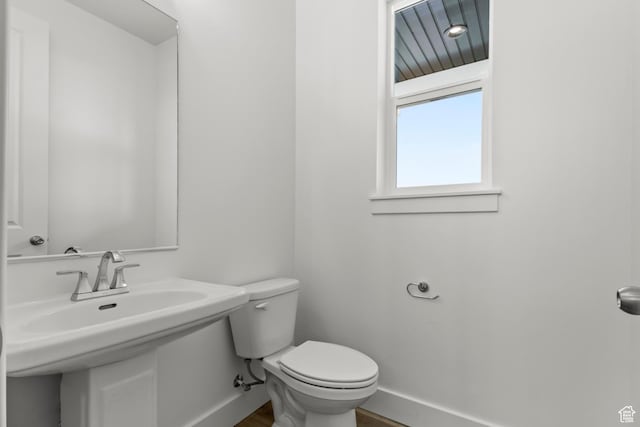 2372 W 2950 N Unit 108, Farr West, UT 84404 - half bath featuring toilet, wood finished floors, and baseboards