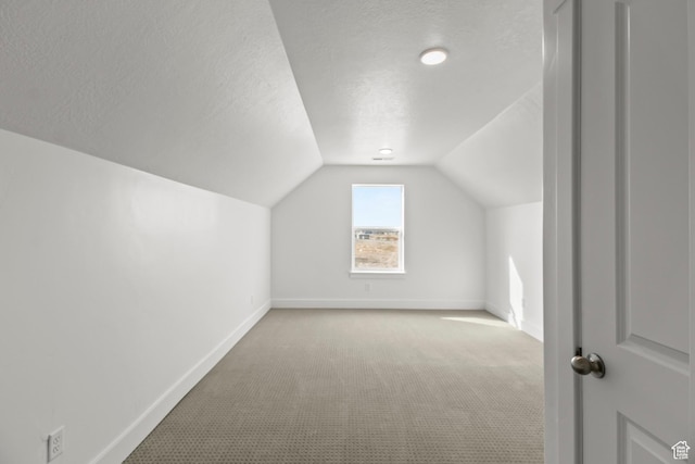 2372 W 2950 N Unit 108, Farr West, UT 84404 - additional living space with a textured ceiling, carpet flooring, vaulted ceiling, and baseboards