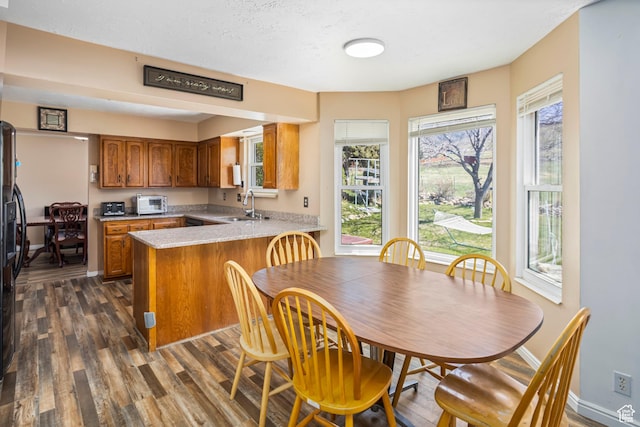 614 Mountaineer Cir, Tooele, UT 84074 - dining space featuring dark wood-style flooring and baseboards