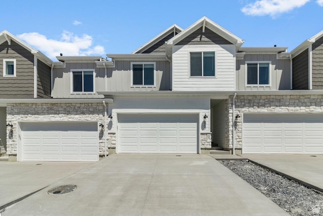 657 W 575 N, Smithfield, UT 84335 - multi unit property featuring board and batten siding, an attached garage, stone siding, and driveway
