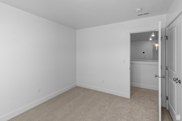 unfurnished bedroom featuring baseboards, visible vents, carpet floors, and a closet