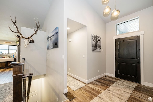 9568 N 5600 W, Elwood, UT 84337 - foyer with a chandelier, vaulted ceiling, wood finished floors, and baseboards
