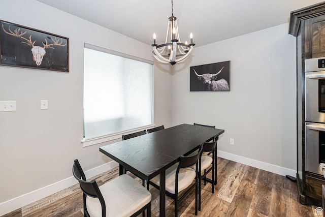 9568 N 5600 W, Elwood, UT 84337 - dining area with baseboards, wood finished floors, and an inviting chandelier