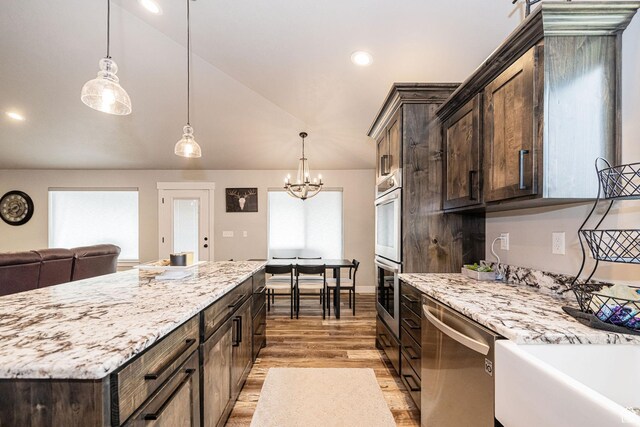 9568 N 5600 W, Elwood, UT 84337 - kitchen featuring a chandelier, appliances with stainless steel finishes, dark brown cabinets, light wood-type flooring, and lofted ceiling