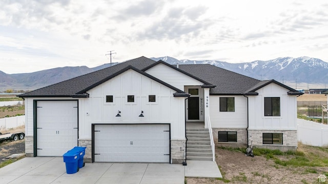 9568 N 5600 W, Elwood, UT 84337 - view of front of house featuring board and batten siding, a mountain view, and stone siding