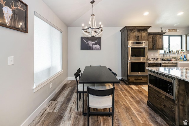 9568 N 5600 W, Elwood, UT 84337 - kitchen featuring lofted ceiling, a chandelier, stainless steel appliances, dark brown cabinets, and dark wood-style flooring