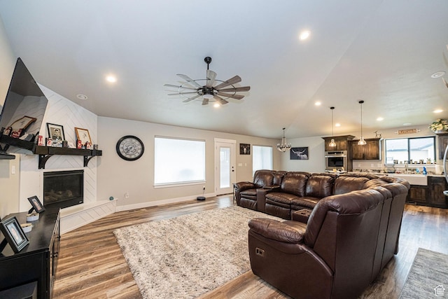 9568 N 5600 W, Elwood, UT 84337 - living area featuring a tile fireplace, wood finished floors, a ceiling fan, and recessed lighting
