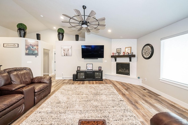9568 N 5600 W, Elwood, UT 84337 - living area featuring wood finished floors, a large fireplace, baseboards, a ceiling fan, and lofted ceiling