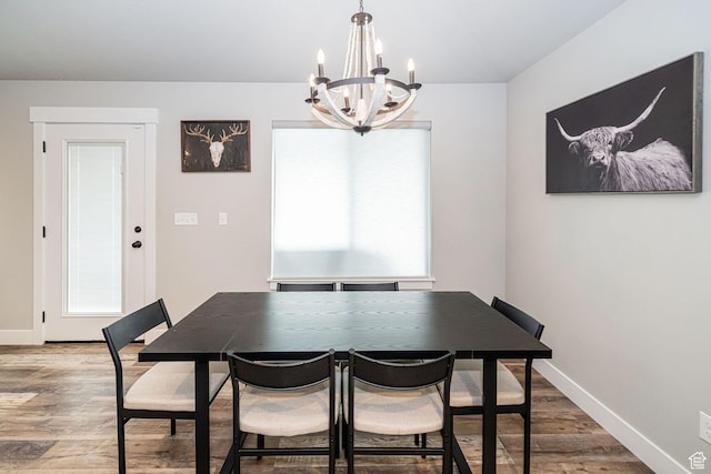 9568 N 5600 W, Elwood, UT 84337 - dining area with an inviting chandelier, baseboards, wood finished floors, and plenty of natural light