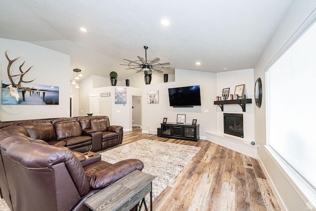 9568 N 5600 W, Elwood, UT 84337 - living area featuring a large fireplace, a ceiling fan, vaulted ceiling, baseboards, and wood finished floors