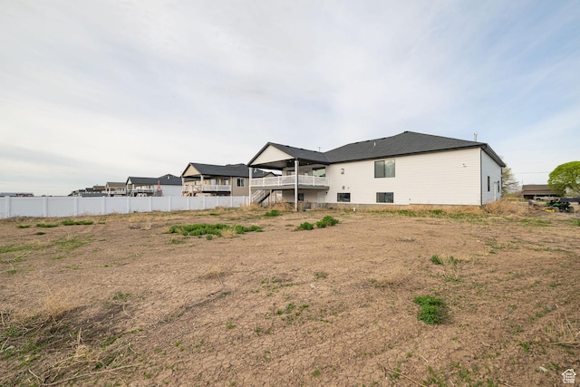 9568 N 5600 W, Elwood, UT 84337 - rear view of house with a deck, stairway, and fence