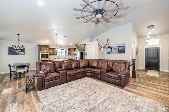 9568 N 5600 W, Elwood, UT 84337 - living room with light wood finished floors, baseboards, vaulted ceiling, and ceiling fan with notable chandelier