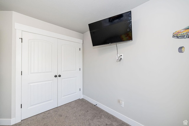 9568 N 5600 W, Elwood, UT 84337 - unfurnished bedroom with a closet, carpet, and baseboards
