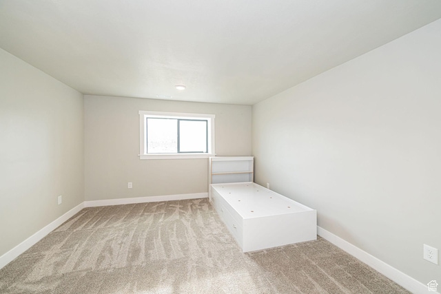 9568 N 5600 W, Elwood, UT 84337 - unfurnished bedroom featuring baseboards and light carpet