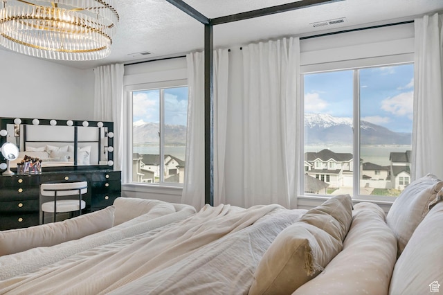 2862 S Preening Way, Saratoga Springs, UT 84045 - bedroom with a chandelier, visible vents, a textured ceiling, and a mountain view