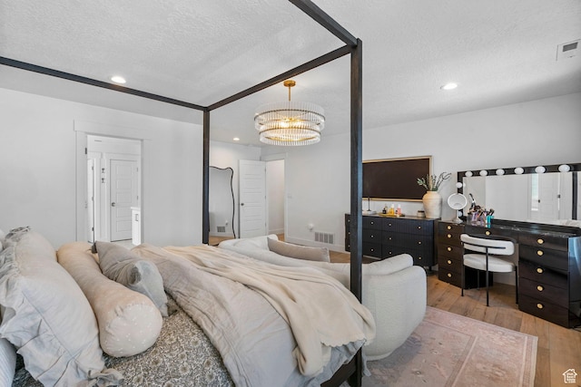 2862 S Preening Way, Saratoga Springs, UT 84045 - bedroom with recessed lighting, wood finished floors, visible vents, a notable chandelier, and a textured ceiling