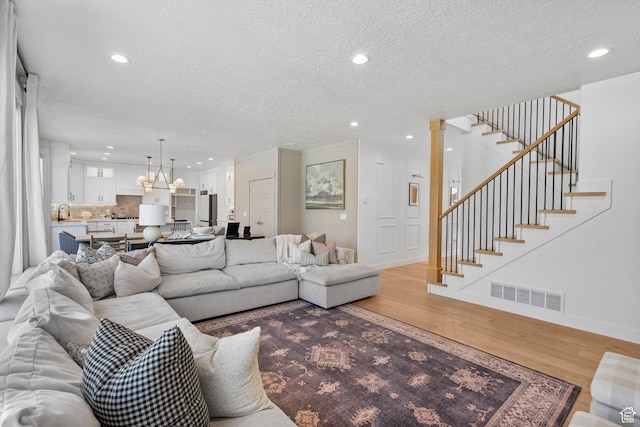 2862 S Preening Way, Saratoga Springs, UT 84045 - living room with recessed lighting, visible vents, a chandelier, and light wood-type flooring