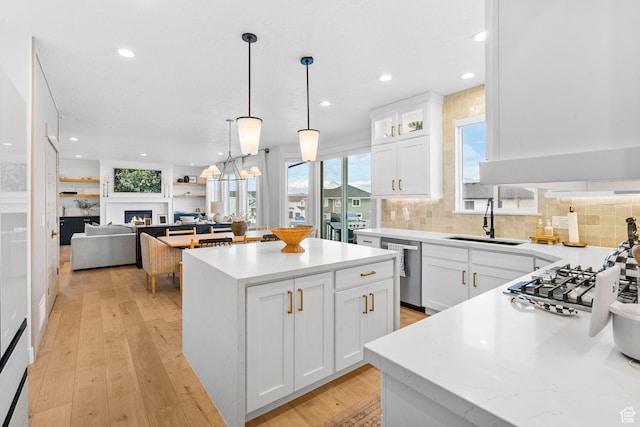 2862 S Preening Way, Saratoga Springs, UT 84045 - kitchen with a sink, decorative backsplash, stainless steel appliances, a kitchen island, and white cabinetry