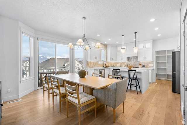 2862 S Preening Way, Saratoga Springs, UT 84045 - dining room with recessed lighting, light wood-style flooring, baseboards, visible vents, and a textured ceiling