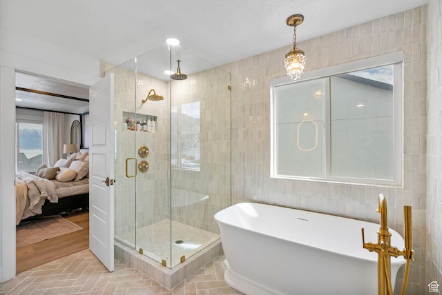 2862 S Preening Way, Saratoga Springs, UT 84045 - bathroom featuring a freestanding tub, a shower stall, ensuite bath, and tile walls