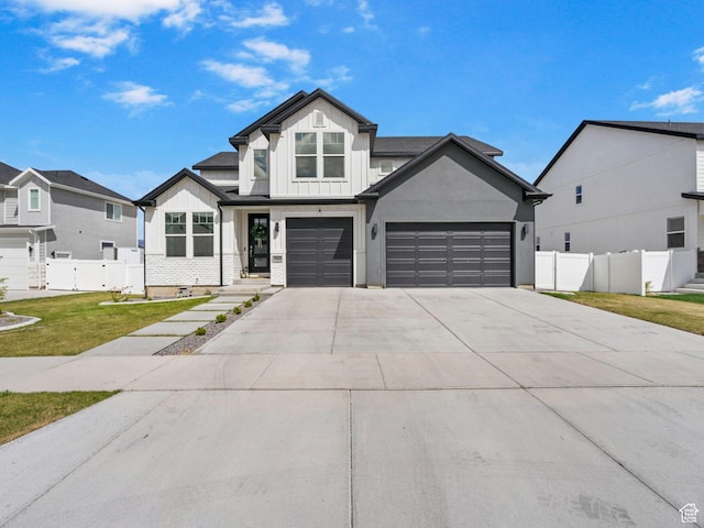 2862 S Preening Way, Saratoga Springs, UT 84045 - modern farmhouse style home featuring a front yard, driveway, board and batten siding, an attached garage, and fence