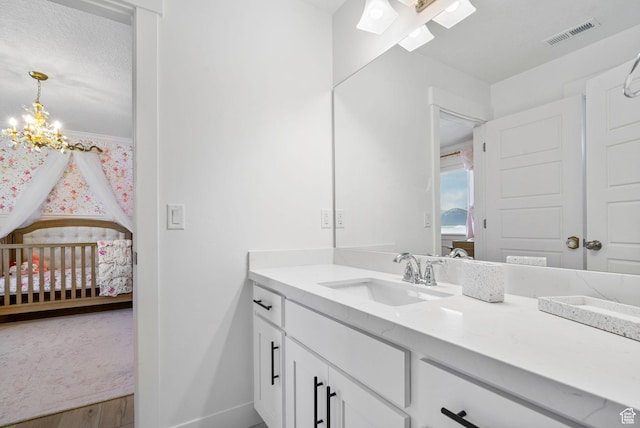 2862 S Preening Way, Saratoga Springs, UT 84045 - ensuite bathroom with a skylight, an inviting chandelier, vanity, baseboards, and visible vents