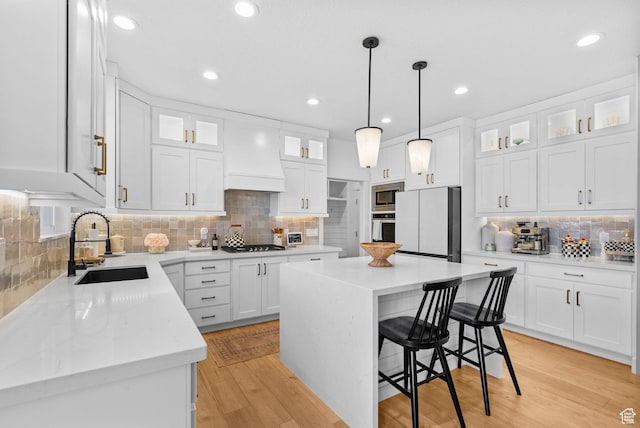2862 S Preening Way, Saratoga Springs, UT 84045 - kitchen featuring white cabinets, a sink, stainless steel appliances, a kitchen island, and backsplash
