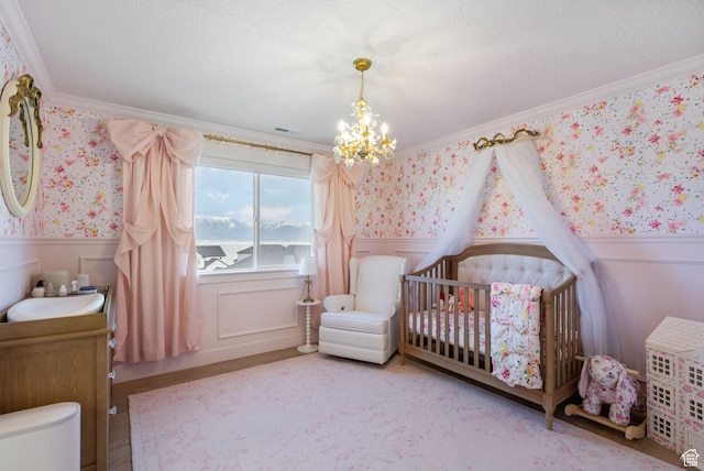 2862 S Preening Way, Saratoga Springs, UT 84045 - bedroom with crown molding, a wainscoted wall, a notable chandelier, and wallpapered walls