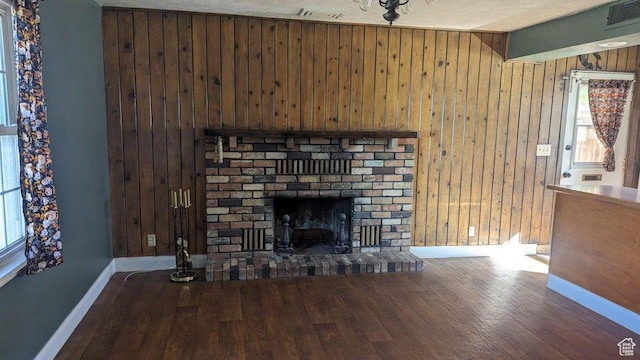 252 N Highland Dr, Cedar City, UT 84721 - unfurnished living room featuring wooden walls, visible vents, wood finished floors, and baseboards